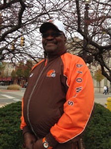 Royce Brown, a man who believes that smiling for long enough will bring out the sun, smiles while telling his story in Downtown Barberton.